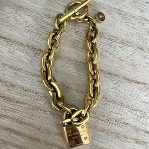 Michael Kors gold plated chain bracelet with lock pendent